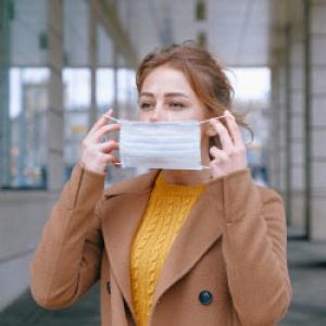 Woman Putting on a face mask